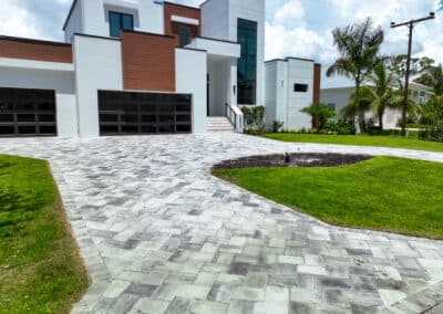 A frontview of a building with a clean paved driveway